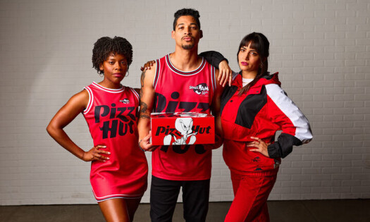 Three people wear the new Pizza Hut x Space Jam branded apparel