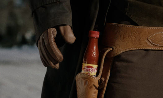 A cowboy reaching for his Texas Pete hot sauce