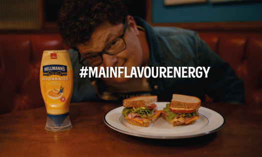 Jesse Heiman behind a sandwich using Hellmann's