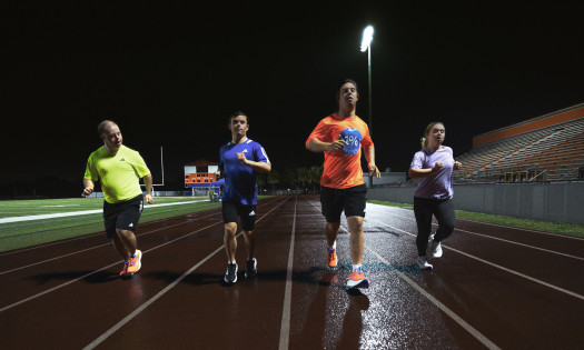 Athletes with down syndrome run on a track wearing Adidas