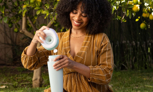 A woman pictured using a Breast Milk Cooler from Willow