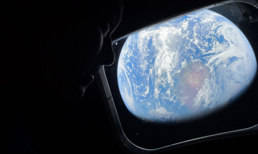 A photo of Commander Reid Wiseman looking at Earth from orbit, shot on an iPhone 17 Pro Max