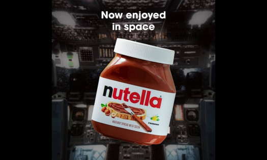 Jar of Nutella floating in zero gravity inside NASA’s Artemis II spacecraft cabin as astronauts work in the background.