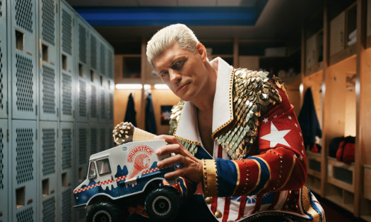 Cody Rhodes in the locker room holding up Drumstick ice cream