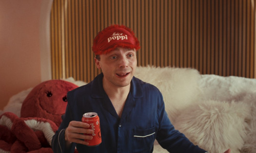 Jake Shane holding a poppi while in his pajamas