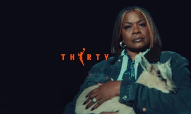 WNBA legend Sheryl Swoopes appears in the Season 30 “Raising GOATs” campaign, holding a goat against a dark background with “THIRTY” displayed in bold orange text.