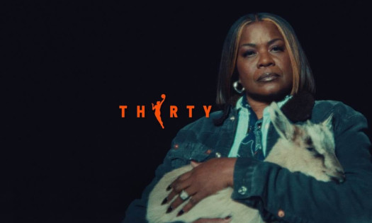 WNBA legend Sheryl Swoopes appears in the Season 30 “Raising GOATs” campaign, holding a goat against a dark background with “THIRTY” displayed in bold orange text.