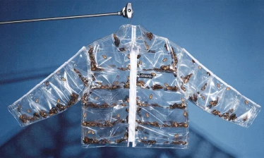 Transparent Roachcoat jacket filled with live cockroaches, created by Uncommon NY in response to the New York Knicks "cockroach" remark, displayed against a blue background.