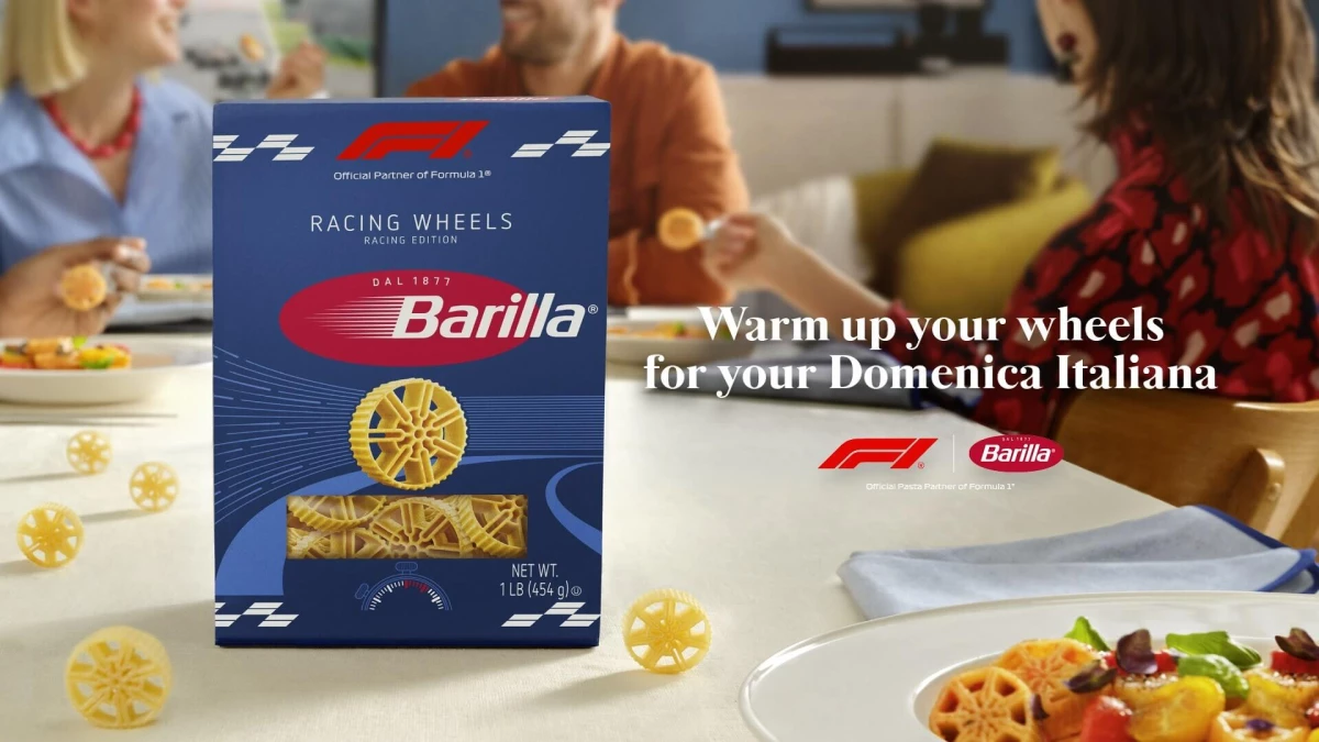 Barilla Racing Wheels pasta packaging on a dining table, with wheel-shaped pasta pieces and a plated dish, highlighting the brand’s Formula 1-inspired design and race-day dining concept.