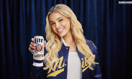 Livvy Dunne holding up a can of Miller Lite