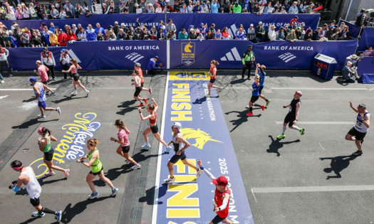A photo showing runners crossing the finish line at the 2026 Boston Marathon