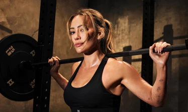 Hilary Duff lifting weights in the gym