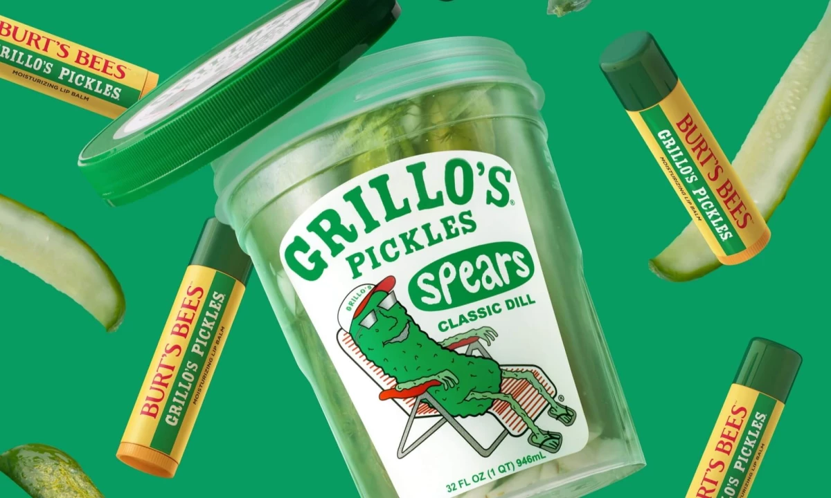 Limited-edition Burt’s Bees x Grillo’s Pickles cucumber dill lip balm packaging displayed with a pickle jar on a green background.