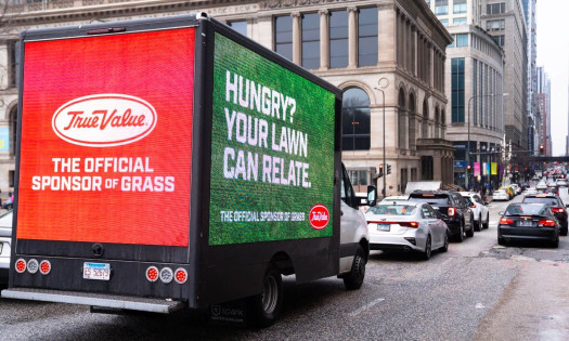 The Official Sponsor of Grass digital billboard on truck with the words: "Hungry? Your lawn can relate."