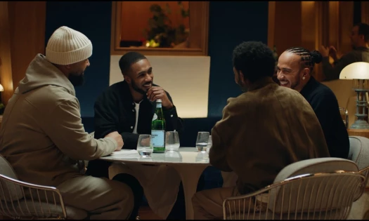 Lewis Hamilton in a dinner table enjoying S.Pellegrino