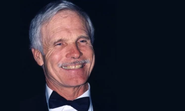 Profile of Ted Turner in a tuxedo.