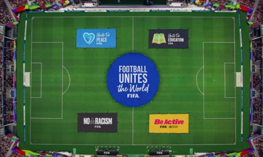 Aerial view of a football pitch with stretch banners of FIFA's various social impact campaigns.
