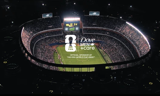 Dove Men+Care FIFA World Cup 2026 campaign visual showing a packed stadium with the brand’s official sponsor logo on the pitch.
