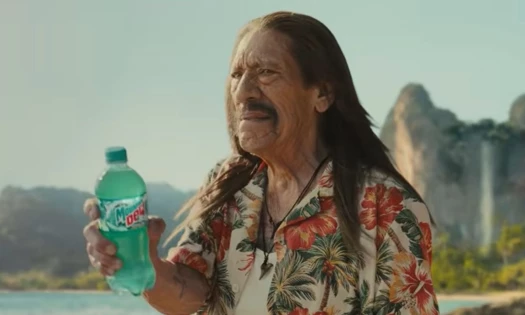 Danny Trejo holding Mountain Dew Baja Blast on a beach