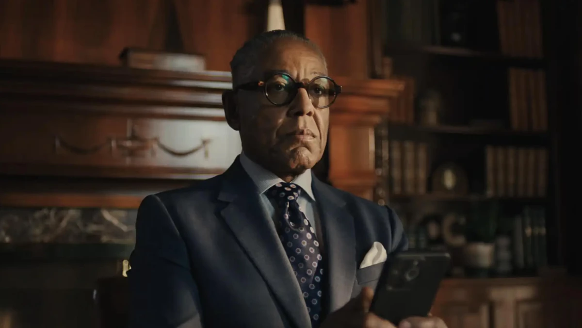 Giancarlo Esposito in a suit using his phone