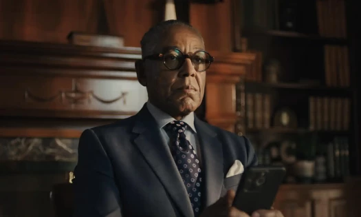 Giancarlo Esposito in a suit using his phone