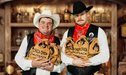 Caleb Pressley and Glenny Balls holding Chica~Chida Nutsack burlap sacks in cowboy outfits