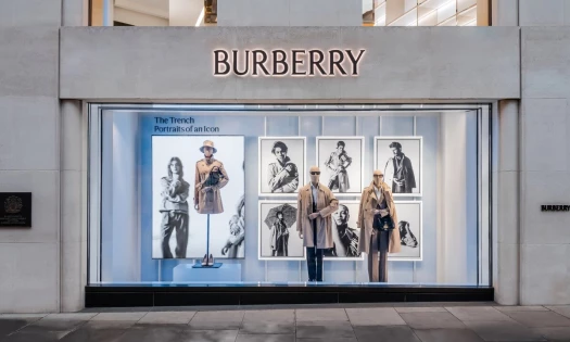 Burberry storefront window displaying trench coats and campaign imagery for The Trench: Portraits of an Icon.