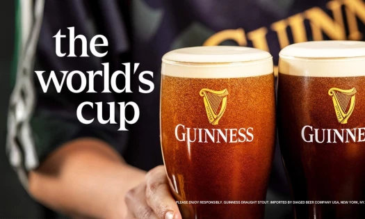 Guinness draughts served by a bartender wearing branded merch for the brand's "The World's Cup" campaign.