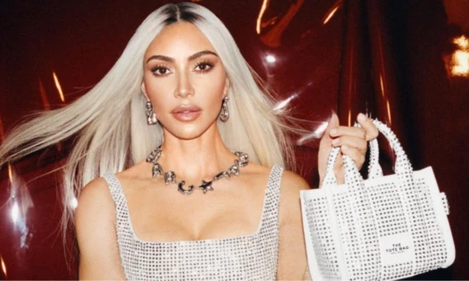 Kim Kardashian holding a bedazzled white Marc Jacobs Tote Bag