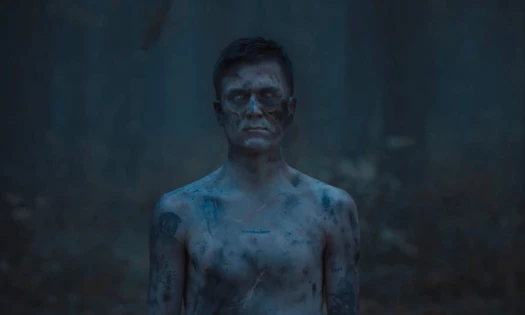 Jakob Ingebrigtsen moves through a dark forest under the word “Fearless” in COROS’ Pace 4 watch campaign.