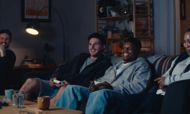 Declan Rice on a couch playing video games with friends