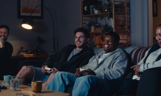 Declan Rice on a couch playing video games with friends