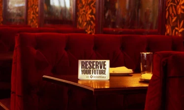 An empty table with a signage that reads: "Reserve Your Future"