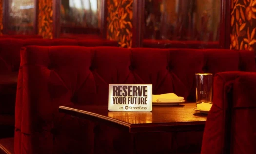 An empty table with a signage that reads: "Reserve Your Future"