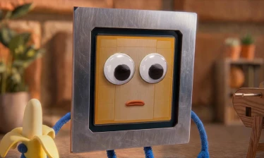 A small puppet TP chip holding a banana