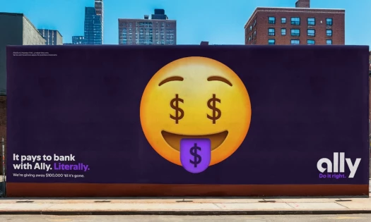 Ally money emoji OOH with the caption "It pays to bank with Ally. Literally."