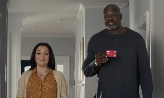 Shaquille O'Neal standing beside a woman in a living room