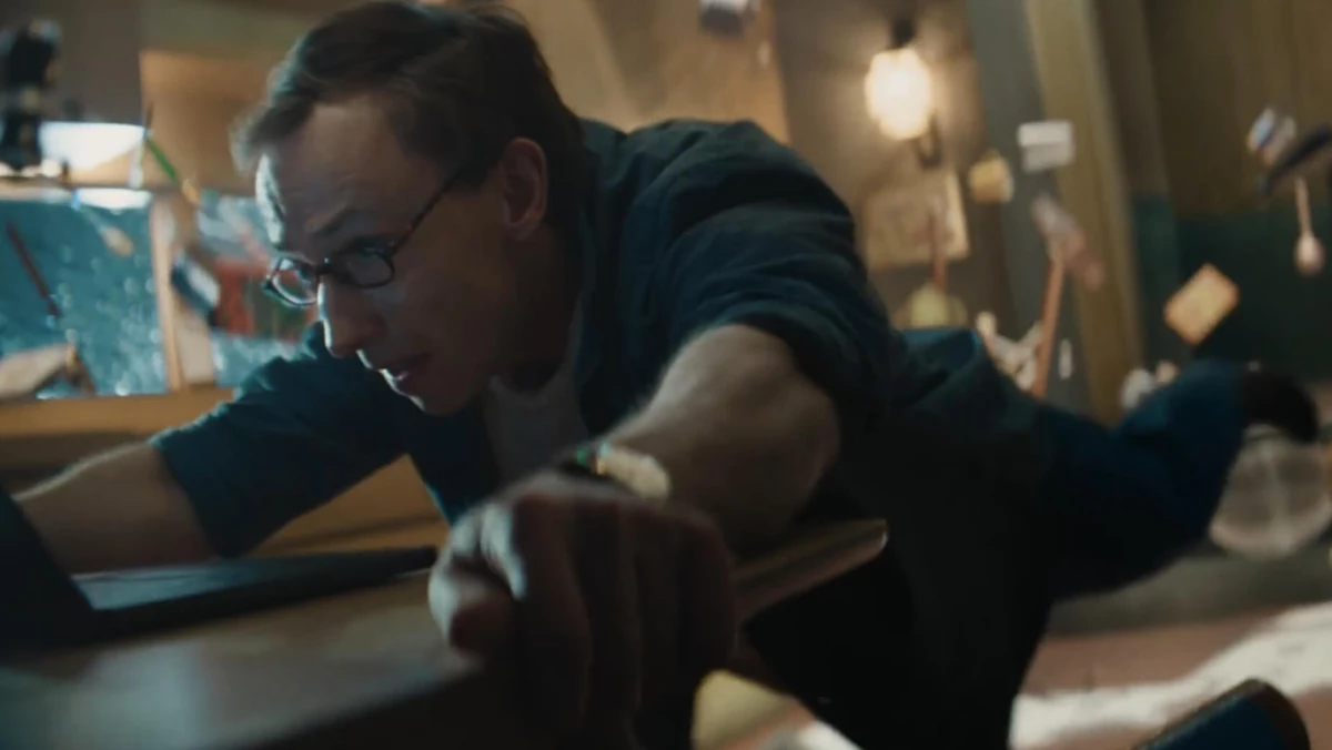 A man holding onto his desk