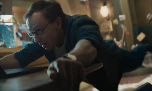 A man holding onto his desk
