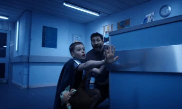 A kid and his dad in a hallway