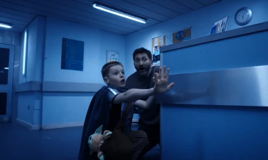 A kid and his dad in a hallway