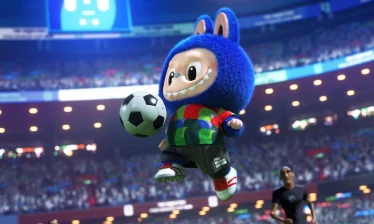 A Labubu figure in a FIFA World Cup jersey kicks a soccer ball inside a packed stadium.