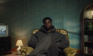 Bukayo Saka sitting on a chair