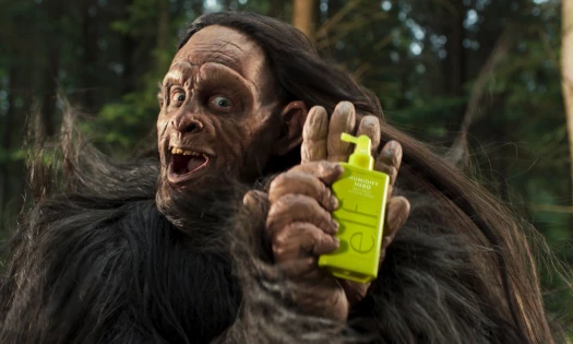 Bigfoot excitedly holds up e.l.f. Hair Humidity Hero.