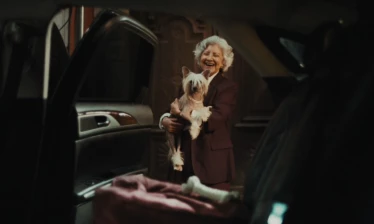 An elderly woman with her puppy