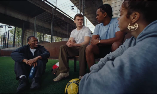 A group of friends talking over a football session