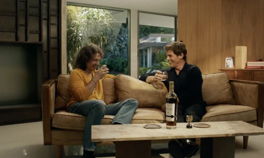 James Marsden and his son Jack talking with a bottle of Macallan on the table