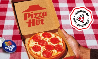 A small pan pizza from Pizza Hut with a "BOOK IT!" pin