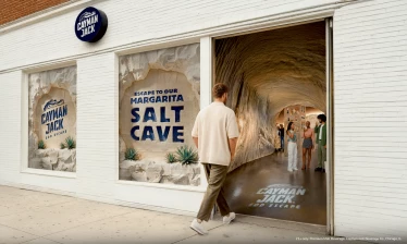 A man enters the Cayman Jack EOD Escape margarita salt cave in New York as guests gather inside the branded activation.
