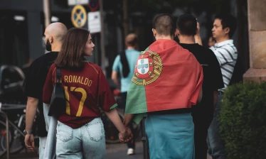 Two football fans walking side by side